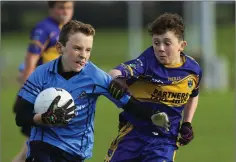  ??  ?? Michael Dwyers’ Conor Byrne is challenged by Tomacork’s Daniel Redmond during the U-13 Shield final in Ballinakil­l. Picture: Garry O’Neill