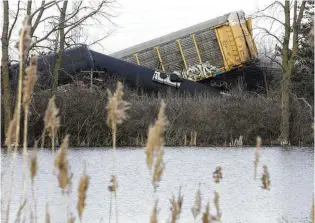  ?? BILL LACKEY/STAFF FILE 2023 ?? Multiple cars of a Norfolk Southern cargo train lie toppled on one another after derailing at a train crossing with Ohio 41 in Clark County on March 4, 2023.