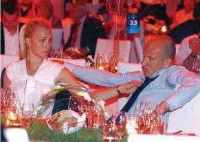  ??  ?? Disconsola­te: Arjen Robben of Bayern Munich and his wife Bernadien during the club’s banquet in Munich on Sunday. — EPA