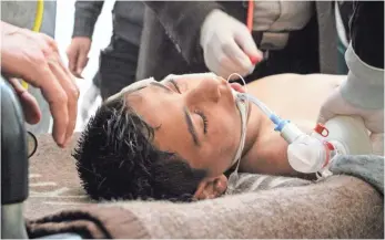  ?? EUROPEAN PRESSPHOTO AGENCY ?? A victim receives treatment Tuesday at a field hospital in Saraqib, Syria. The Syrian Observator­y for Human Rights alleged a chemical attack on the rebel-held area of Idlib province.