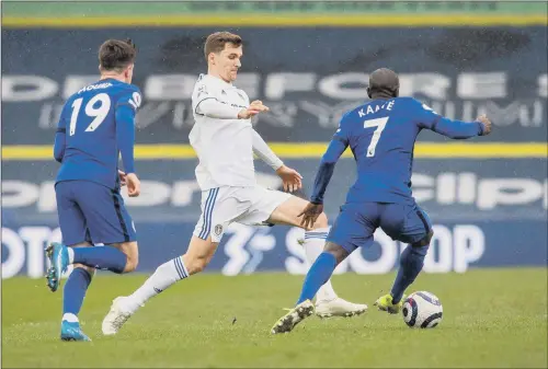 ?? SETTLING IN: PICTURE BRUCE ROLLINSON ?? Leeds United’s Diego Llorente goes past Chelsea duo Mason Mount and N’Golo Kante at Elland Road last weekend.