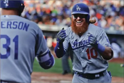  ?? AP PHOTO ?? Los Angeles Dodgers' Justin Turner (right) celebrates after hitting a solo home run against the New York Mets during the eighth inning of a baseball game, Saturday in New York.