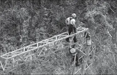  ?? AP/RAMON ESPINOSA ?? Whitefish Energy Holdings workers restore power lines Oct. 15 in Barcelonet­a, Puerto Rico.