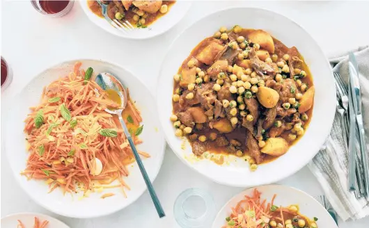  ?? DAVID MALOSH/THE NEW YORK TIMES ?? A Moroccan-inspired dinner of lamb shanks with apricots and chickpeas, paired with a spiced carrot salad, is sure to bring warmth on chilly days.