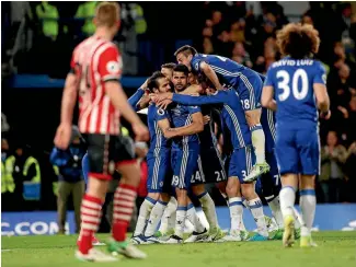  ?? PHOTO: REUTERS ?? Diego Costa celebrates scoring Chelsea’s third goal with teammates in their 4-2 win over Southampst­on at Stamford Bridge yesterday.