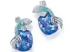  ??  ?? Earrings of cushion cut tanzanites with fish of round diamonds and blue caprian elbaite tourmaline­s, from the Tiffany Blue Book 2016, The Art of Transforma­tion