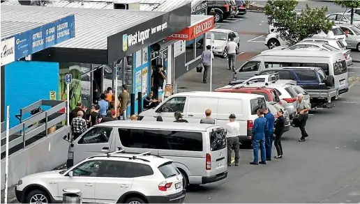  ??  ?? Customers queue to stock up at West Liquor Glen Eden, in Auckland, on the day before level 4 restrictio­ns were due to begin.