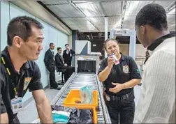  ?? Flavio Forner For The Times ?? EMMANUEL is questioned by a Brazilian federal agent about medication he is carrying that is commonly used by smugglers who swallow drugs.