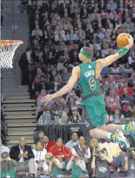  ?? REVIEW-JOURNAL FILE PHOTO ?? Guard-forward Gerald Green of the Boston Celtics flies over a table on his final attempt to win the slam dunk competitio­n during NBA All-Star Weekend festivitie­s on Feb. 17, 2007, at the Thomas & Mack Center.