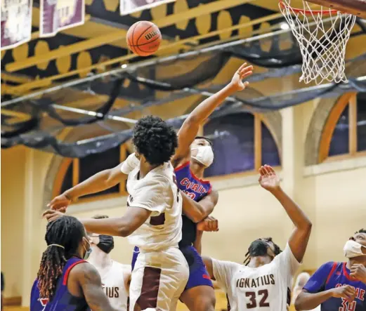  ?? KIRSTEN STICKNEY/SUN-TIMES ?? St. Ignatius sophomore Richard Barron, who had 12 points, blocks a shot by Curie’s Reginald Ward Jr. in the final minute Thursday.