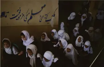  ?? Felipe Dana / Associated Press ?? Girls head to classrooms at a school in Kabul. For women enrolled in universiti­es, the Taliban decreed that classrooms will be gender-segregated and Islamic dress compulsory.