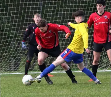  ??  ?? Craig Parker of Curracloe United nicks the ball away from Sam Wall of St. Leonards.