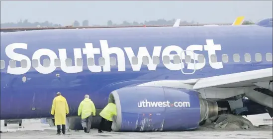  ?? Myung J. Chun Los Angeles Times ?? A SOUTHWEST f light slid off the runway at Burbank airport, stopping after its landing gear plowed into a barrier designed to keep planes from leaving the runway.