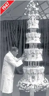  ??  ?? A confection­er from McVitie and Price fine-tunes the Queen and Philip’s 9ft cake