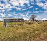  ?? ?? The rear yard is partially fenced, has two wood decks and overlooks farmland.