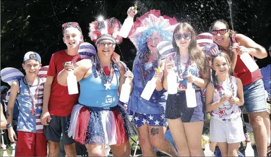  ?? ?? From left, Ryder Ribello, 10, Brayden Ribello, 13, of Cumberland, Jen Sunday, of North Attleboro, Heather Shepherd, of Bellingham, and Hannah Kelleher, 13, Shannon Kelleher, 9, and Jessica Kelleher, all of Cumberland, are ready for a water gun fight during the annual Arnold Mills 4th of July Parade in Cumberland Monday. “We come prepared,” said Shepherd.