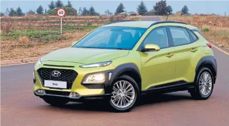  ??  ?? Above: Handsome but polarising looks give character to Hyundai s Kona crossover. Below: The cargo area can swallow nearly as much as its Creta sibling. Below left: The cabin in lime or red accents has a cool appeal factor.
