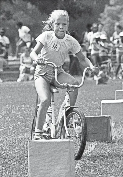  ?? THOMAS BUSLER/THE COMMERCIAL APPEAL FILE ?? Trina Mckinney clenches her lips as she weaves through a slalom course during the Overton Park Bicycle Derby on July 28, 1984. Some 250 children ages 7-12 showed their skill in dealing with obstacles, braking, slow-speed balance and maneuverin­g in the event sponsored by the Memphis Park Commission.