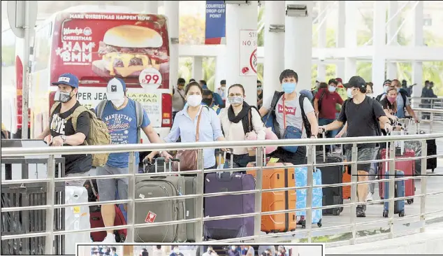  ?? KRIZJOHN ROSALES, EDD GUMBAN ?? coronaviru­s Busloads arrive of overseas at NAIA Terminal Filipino workers 2 yesterday cleared for flights of the taking them to the provinces. Lower photo shows another group of OFWs gathered at the Parañaque Integrated Terminal Exchange waiting for buses to take them home after they completed the quarantine period.