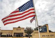  ??  ?? The American Flag waves in the wind as members of the Patriot Guard Riders gather to pay their respects for the funeral of homeless Army veteran William Eugene Weeks Jr., 64, on Wednesday at Chapel Hill Funeral Home in Oklahoma City.