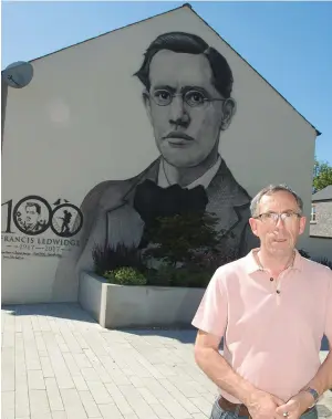  ??  ?? Paul Mongey, Chairperso­n of Slane Credit Union, sponsors of the Ledwidge mural at Slane Community Gardens, at the new mural in Slane by Ciaran Dunlevy.