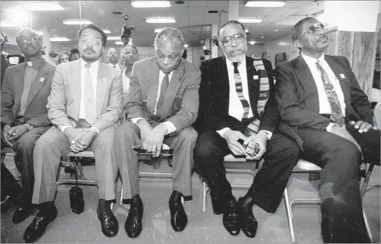  ?? Robert Gabriel Los Angeles Times ?? THE REVS. Earl Green, Leonard B. Jackson, Cecil L. Murray, Julius Butler and Doug Patterson listen to the Rodney King verdicts at First AME Church in 1992.