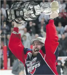  ?? DAN JANISSE ?? Spitfires centre Aaron Luchuk hoists the Memorial Cup Sunday. A victory parade is set for Wednesday at 6 p.m. along Ouellette Avenue.