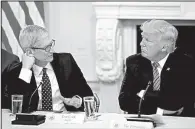  ?? AP/ALEX BRANDON ?? Apple CEO Tim Cook speaks with President Donald Trump at an American Technology Council session in the State Dinning Room of the White House in June.