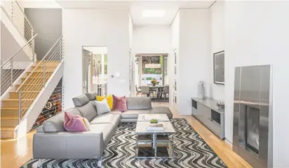  ?? Photos by Paul Rollins Photograph­y ?? Above: The living room at 47 Clarendon Ave. in Clarendon Heights features a gas fireplace with a stainless steel surround. Right: The three-bedroom contempora­ry in Clarendon Heights is listed for $3.575 million.