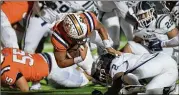  ?? COURTESYOF DANIEL VARNADO ?? North Cobb quarterbac­k Malachi Singleton (center) dives into theendzone­overMariet­ta’s LukeMorgan late in Friday’s game in Kennesaw.