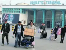  ?? Omar Sobhani / Reuters ?? Afghans, whose asylum applicatio­ns were rejected, arrive in Kabul after deportatio­n from Germany.