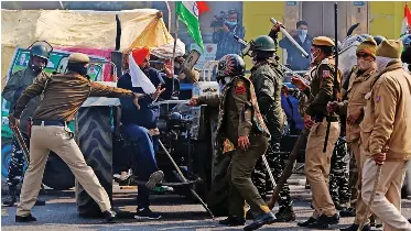 PO­LICE of­fi­cers scuf­fle with a demon­stra­tor dur­ing a protest against farm laws in New Delhi, yes­ter­day.
