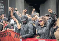  ?? LOGAN CYRUS/AFP/GETTY IMAGES ?? Members of ANTIFA demonstrat­ed after going through a security checkpoint in downtown Charlottes­ville.