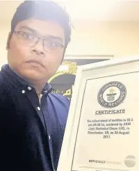  ??  ?? ●●Joy Ehsan with his certificat­e from Guinness World Records