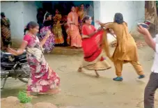  ?? — DC ?? A woman constable scuffles with a protester while others try to take refuge in huts following the police crackdown in Medak on Sunday.