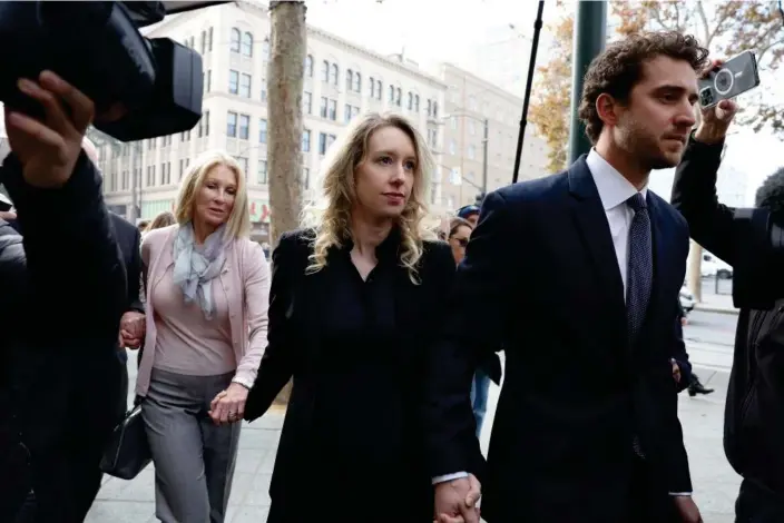  ?? Photograph: Justin Sullivan/Getty Images ?? ▲ Elizabeth Holmes arrives with her family and partner, Billy Evans, to be sentenced on Friday.