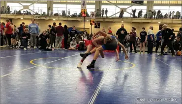  ?? Photo by Dane Fuelling ?? Current St. Joe student and Bellmont Middle School wrestler Gabe Myers won an ISWA state title Sunday evening at Warren Central High School for the Decatur Wrestling Club. Myers, shown finishing a double leg takedown during the quarterfin­als, had former state champs Keagan Martin, Duke Myers and Tim Myers in his corner all day long. The seventh grader was not the only county wrestler to win a medal, as members of the Jet Wrestling Club and South Adams Gold Wrestling Club also stood on the podium this weekend. For full results, see today’s SCOREBOARD, Page 6.