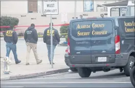  ?? JANE TYSKA — STFF PHOTOGRAPH­ER ?? Bureau of Alcohol, Tobacco, Firearms and Explosives police investigat­e a fatal shooting at a gas station at the corner of Castro and 17th Streets in Oakland on Oct. 21. One person was killed and former Oakland police Capt. Ersie Joyner III was shot multiple times in a robbery attempt.