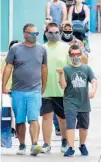  ?? JOE BURBANK/TNS ?? Guests wear face masks Wednesday while visiting the Disney Springs shopping and dining district in Lake Buena Vista.