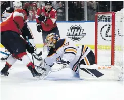  ?? — THE ASSOCIATED PRESS ?? Panthers winger Evgenii Dadonov scores on Oilers goaltender Cam Talbot during second-period action Thursday in Sunrise, Fla.