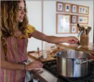  ?? PHOTO BY DENISE WOODWARD ?? Allison Arevalo adds salt to boiling water as she prepares for Pasta Friday, a weekly dinner night with family and friends at her home in Rockridge, Calif.