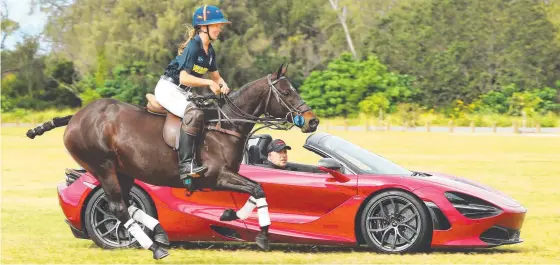  ?? Picture: GLENN HAMPSON ?? Polo player Indiana Bennetto and her trusty horse Tui race V8 Supercars legend Paul Morris and his McLaren 720S ahead of Polo by the Sea.