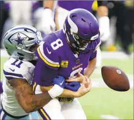  ?? Andy Clayton-King Associated Press ?? VIKINGS quarterbac­k Kirk Cousins is stripped of the ball as Cowboys linebacker Micah Parsons sacks him. Cousins was sacked a career-high seven times.