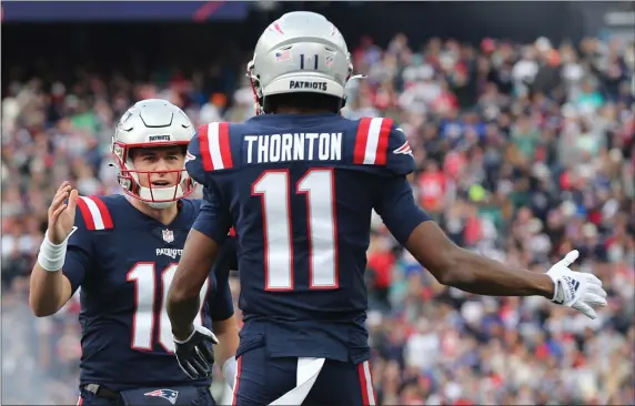  ?? STAFF PHOTO BY NANCY LANE — BOSTON HERALD ?? New England Patriots wide receiver Tyquan Thornton celebrates his touchdown with quarterbac­k Mac Jones during the first quarter of the game against the Miami Dolphins at Gillette Stadium on Sunday,January 1, 2023 in Foxboro, MA.