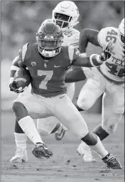  ?? ASSOCIATED PRESS ?? SOUTHERN CALIFORNIA RUNNING BACK STEPHEN CARR (LEFT) runs the ball as Texas defensive lineman Poona Ford (center) and linebacker Malik Jefferson defend during the first half Saturday in Los Angeles.