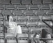  ?? AP/BEN CURTIS ?? Empty seats surround spectators during Wednesday’s quarterfin­al match between John Isner of the United States and Canada’s Milos Raonic at Wimbledon at the same time England was losing to Croatia in the World Cup semifinals. While the Wimbledon men’s...