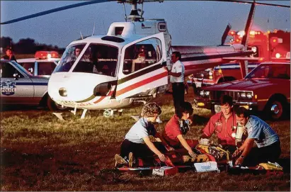  ?? COURTESY OF PREMIER HEALTH ?? Candy Skidmore and other members of CareFlight respond to an accident in 1983, when the CareFlight program began. Skidmore has been with CareFlight since its inception, starting as a flight nurse before becoming an administra­tor. Skidmore has also been Premier Health’s VP of emergency and trauma services over the last decade.