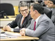  ?? JAY JANNER / AMERICAN-STATESMAN 2014 ?? Then-Gov. Rick Perry (left) and his lawyer Tony Buzbee attend a hearing on an abuse-of-power charge in the 390th District Court on Nov. 6. The state’s highest criminal court will review the case.