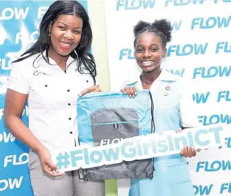  ??  ?? Latoya Lawrence, regional marketing manager at FLOW, presents a token to a student of the Wolmer’s Trust High School for Girls on ICT Day. Lawrence was part of a team from the telecommun­ications firm, which visited the school to give advice on careers...