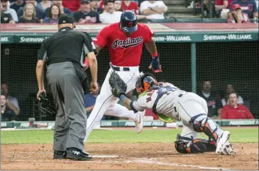  ?? PHIL LONG — THE ASSOCIATED PRESS ?? The Astros’ Marlin Maldonado tags out the Indians’ Yasiel Puig out at home to complete a double play, after a fly out by Franmil Reyes during the fourth inning. Umpire Vic Carapazza watches the play.